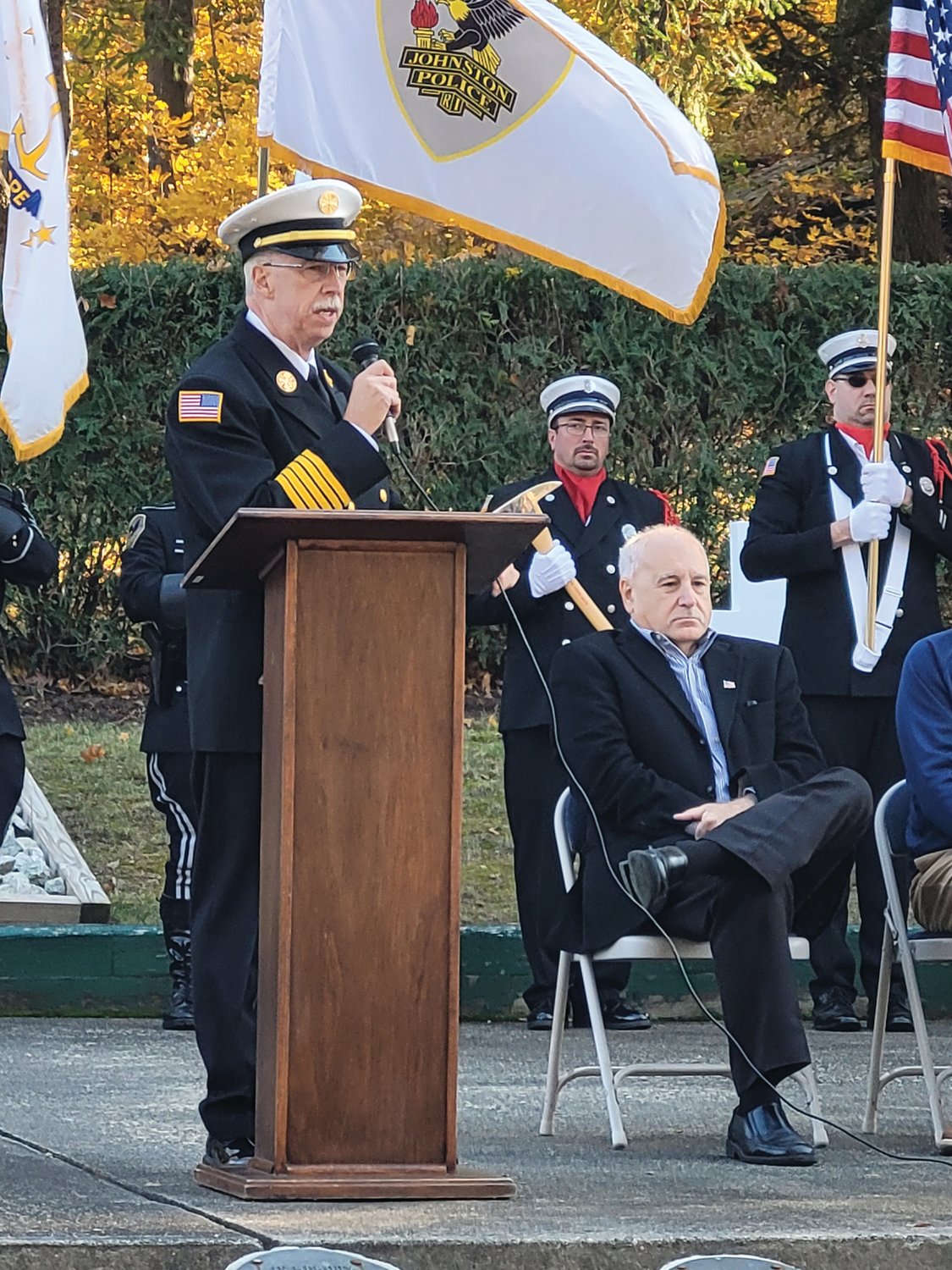 HISTORY LESSON: Johnston Fire Chief Peter J. Lamb explained the significance of the Maltese Cross, a medieval symbol often displayed on firefighters’ uniforms, and on the Johnston War Memorial Park’s newest monument.